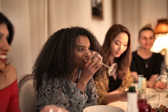 women having a dinner and drinking wine