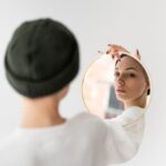 woman looking in the mirror and seeing herself